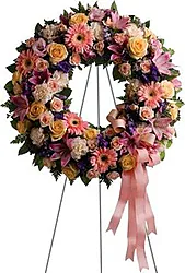 Corona funeraria de rosas pastel, lirios, gerberas y flores mixtas